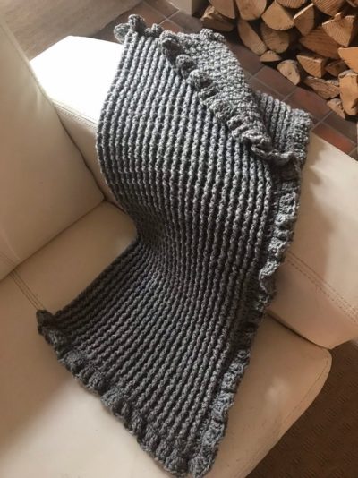 light grey crocheted baby blanket